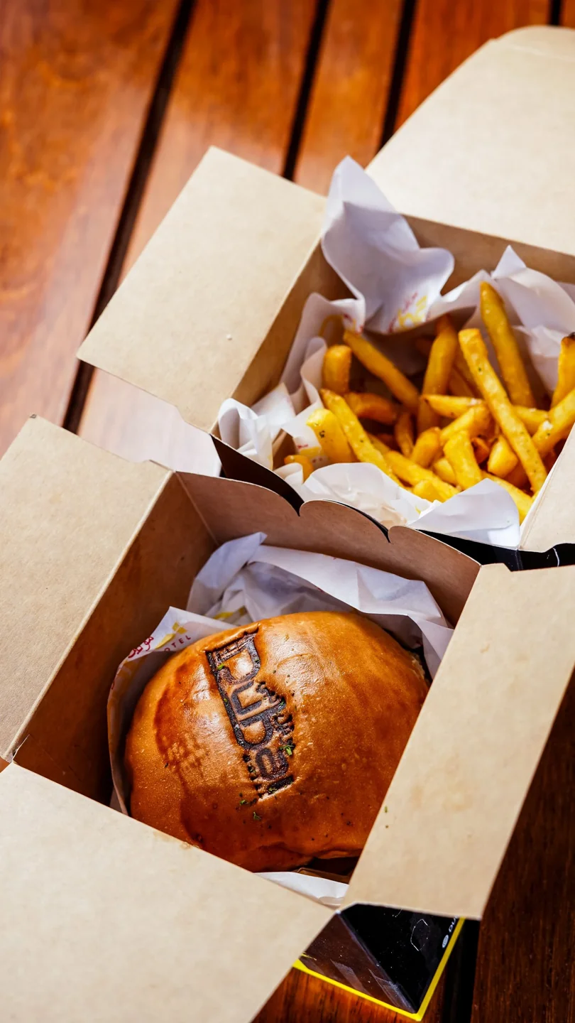 Burger and fries inside a takeaway box