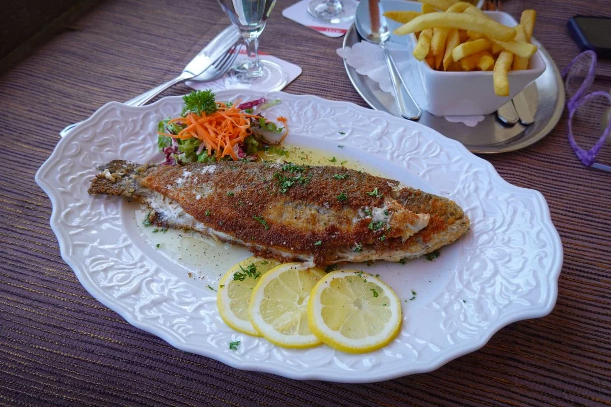 Grilled fish with salad and fries