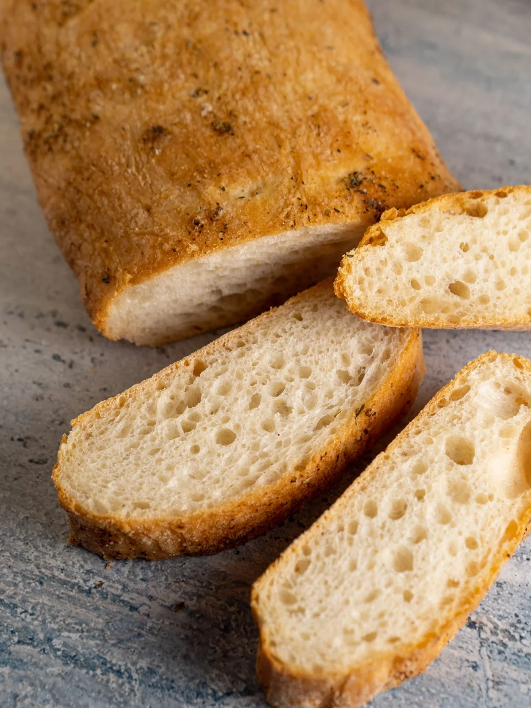 Fresh loaf of bread with slices showing its crumb