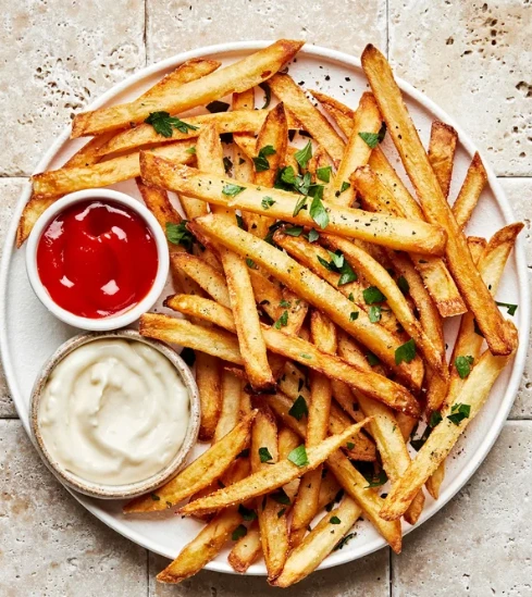 Golden fries with ketchup and creamy dipping sauce
