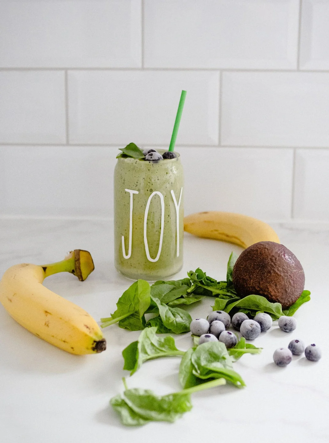 Green smoothie with banana, avocado and berries