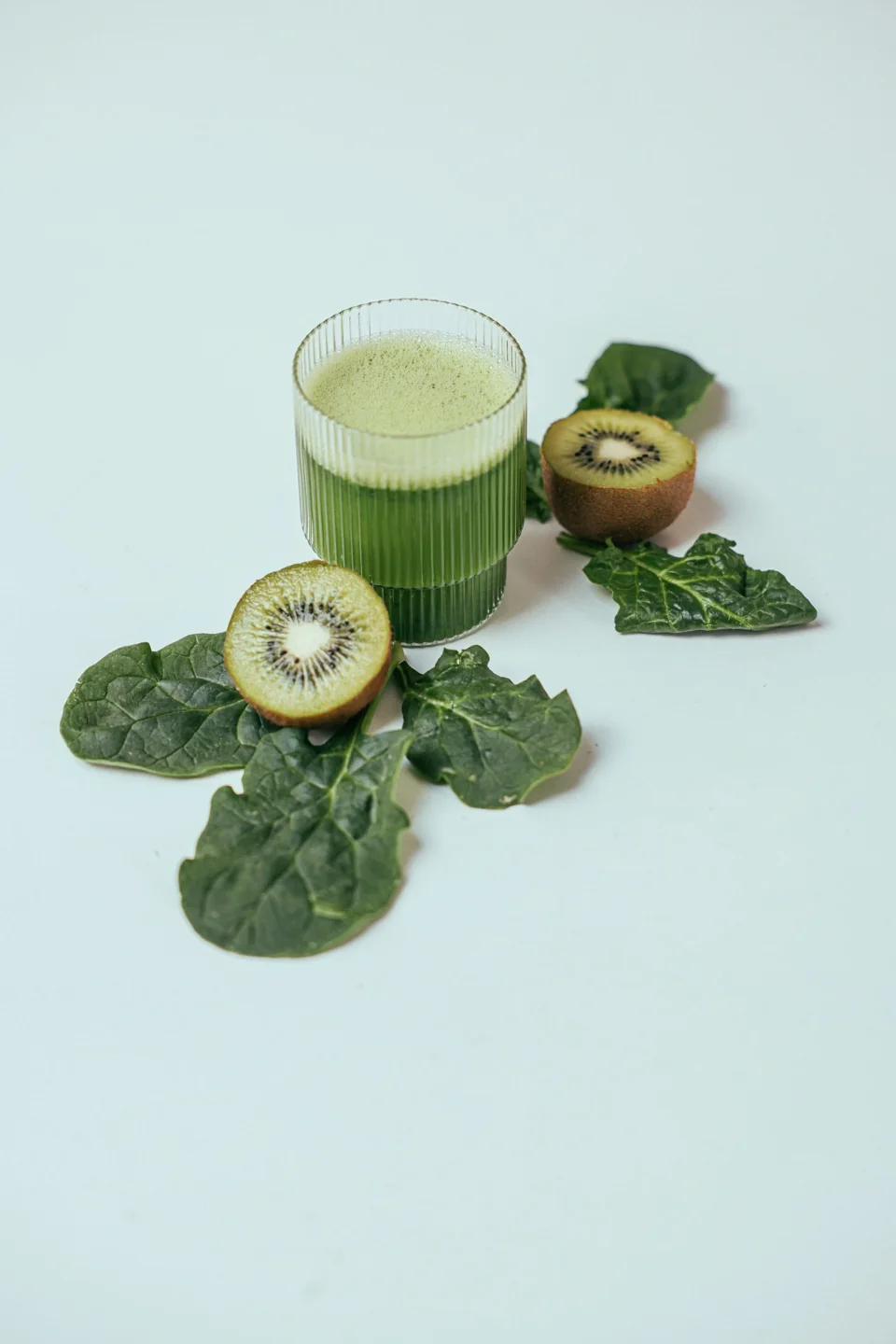 Green juice styled with kiwi fruit and leafy greens