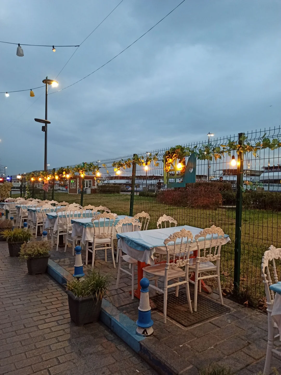Outdoor dining under string lights at dusk