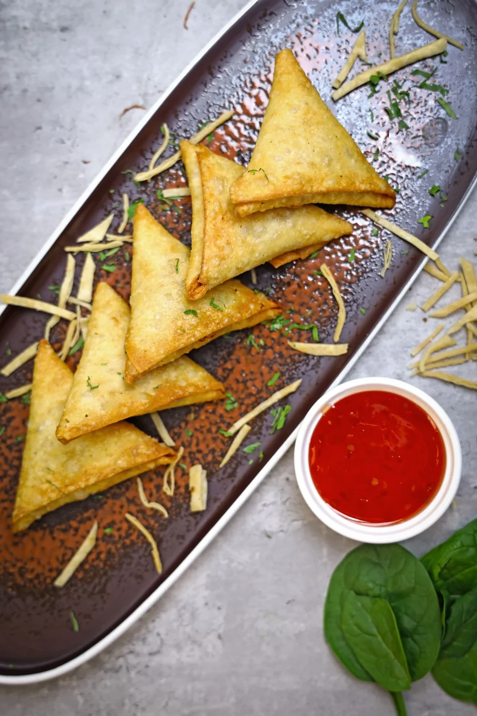 Golden samosas with dipping sauce